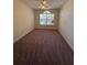 Comfortable carpeted bedroom has large, decorative window at 3807 Plantation Blvd, Leesburg, FL 34748