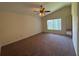 Bright bedroom boasts vaulted ceiling, large window, ceiling fan, and neutral walls at 3807 Plantation Blvd, Leesburg, FL 34748