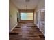 Dining area with wood-look flooring and sliding glass doors to the patio at 3807 Plantation Blvd, Leesburg, FL 34748