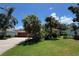 Charming single-story home features lush landscaping and a well-maintained lawn at 3807 Plantation Blvd, Leesburg, FL 34748