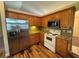 Well-lit kitchen with stainless steel refrigerator and granite countertops at 3807 Plantation Blvd, Leesburg, FL 34748