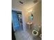 Well-lit powder room boasts pedestal sink and tiled floors at 3807 Plantation Blvd, Leesburg, FL 34748