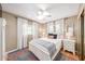 Cozy bedroom featuring a white bed, hardwood floors, and a ceiling fan at 4106 Alverado St, Orlando, FL 32812