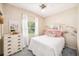 Bedroom featuring a white bed, a dresser, and bright decor at 4106 Alverado St, Orlando, FL 32812