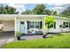 Inviting front porch with seating, landscaping, and a pleasant entryway to this adorable home at 4106 Alverado St, Orlando, FL 32812