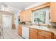 Bright kitchen with a window over the sink, classic wooden cabinets, and neutral countertops at 4106 Alverado St, Orlando, FL 32812