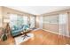 Bright living room with gleaming wood floors, plenty of sunlight, and comfortable furnishings at 4106 Alverado St, Orlando, FL 32812