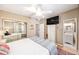 Bright main bedroom with closet, TV, and ensuite bathroom at 4106 Alverado St, Orlando, FL 32812