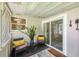 Enclosed porch area with seating, sliding glass door, and decor at 4106 Alverado St, Orlando, FL 32812