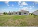 Spacious backyard with lush green grass, perfect for outdoor activities and relaxation at 4266 Wrangler Ln, Mascotte, FL 34753