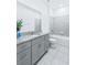 Neutral bathroom featuring tiled shower over tub and gray vanity with granite countertop at 4266 Wrangler Ln, Mascotte, FL 34753