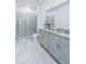 Clean bathroom featuring double sink vanity, granite counters, and glass enclosed shower at 4266 Wrangler Ln, Mascotte, FL 34753