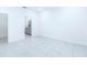A minimal bright bedroom with tiled floors featuring access to a bathroom at 4266 Wrangler Ln, Mascotte, FL 34753