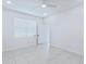 A minimal bright bedroom with tiled floors featuring access to another room at 4266 Wrangler Ln, Mascotte, FL 34753