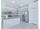 Bright, open kitchen with granite countertops, stainless steel appliances, and tile flooring at 4266 Wrangler Ln, Mascotte, FL 34753