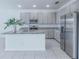 Bright, open kitchen with granite countertops, stainless steel appliances, and tile flooring at 4266 Wrangler Ln, Mascotte, FL 34753