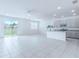 Open-concept living room features tile floors, neutral paint, and sliding glass doors to the backyard at 4266 Wrangler Ln, Mascotte, FL 34753