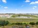 Aerial view of a new community featuring a pond, modern homes, and green spaces at 4343 Juliana Lake Dr, Auburndale, FL 33823