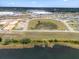 Aerial view of a new community featuring modern homes, a pond, and green spaces along a lake at 4343 Juliana Lake Dr, Auburndale, FL 33823