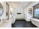 Modern bathroom with double vanity, frameless shower, soaking tub, and decorative tile wall at 4343 Juliana Lake Dr, Auburndale, FL 33823