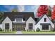 Charming two-story home with gray brick, black framed windows, manicured lawn and beautifully landscaped front yard at 4343 Juliana Lake Dr, Auburndale, FL 33823