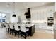 Beautiful kitchen with white cabinets, a black island, stainless steel appliances, and a dining area at 4343 Juliana Lake Dr, Auburndale, FL 33823
