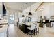 Open kitchen with white cabinets, black island, breakfast bar seating, and vaulted ceilings at 4343 Juliana Lake Dr, Auburndale, FL 33823