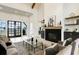 Open-concept living room with fireplace, high ceilings, wood beams, and black framed windows at 4343 Juliana Lake Dr, Auburndale, FL 33823