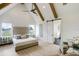 Bright main bedroom featuring a vaulted ceiling with wood beams, a ceiling fan, a tufted headboard, and light wood floors at 4343 Juliana Lake Dr, Auburndale, FL 33823