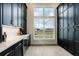 Spacious pantry with black cabinets, quartz counters, and ample storage space at 4343 Juliana Lake Dr, Auburndale, FL 33823