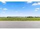 Grassy waterfront property with panoramic lake views on a sunny day at 4343 Juliana Lake Dr, Auburndale, FL 33823