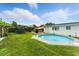 Backyard features a private pool, lush grass, trampoline and shaded dining area at 4629 Spottswood Dr, Orlando, FL 32812