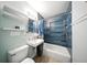 Stylish bathroom featuring blue tiled shower and tub, modern fixtures, and sleek design at 4629 Spottswood Dr, Orlando, FL 32812