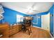 Vibrant blue bedroom featuring a unique loft bed setup, wood flooring, and bright natural light at 4629 Spottswood Dr, Orlando, FL 32812