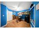 Vibrant blue bedroom featuring a loft bed, desk, shelves and wood-look flooring at 4629 Spottswood Dr, Orlando, FL 32812