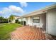 Inviting front porch with brick tiling, offering a cozy outdoor seating area and view of the landscaped yard at 4629 Spottswood Dr, Orlando, FL 32812
