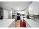 Modern kitchen featuring stainless steel appliances, white cabinets, and a sleek countertop with breakfast bar at 4629 Spottswood Dr, Orlando, FL 32812