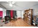 Cozy living room featuring hardwood floors, comfortable seating, and a cabinet with books and decorative items at 4629 Spottswood Dr, Orlando, FL 32812
