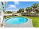 Large pool with ladder surrounded by grass and palm trees offering a relaxing space at 4629 Spottswood Dr, Orlando, FL 32812