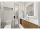 Modern bathroom featuring a frameless glass shower, wood vanity with white countertop, and silver towel rack at 4934 Legacy Oaks Dr, Orlando, FL 32839