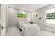 Simply decorated bedroom with a bed, large window with a view, and butterfly wall decor at 4934 Legacy Oaks Dr, Orlando, FL 32839