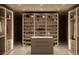 Modern closet with shelving and drawers featuring integrated lighting to highlight shoes, handbags and accessories at 4934 Legacy Oaks Dr, Orlando, FL 32839