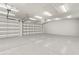 Spacious garage with multiple overhead doors, concrete floor, and ample room for parking and storage at 4934 Legacy Oaks Dr, Orlando, FL 32839