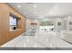 Gourmet kitchen features a large marble waterfall island and a view of the backyard pool at 4934 Legacy Oaks Dr, Orlando, FL 32839