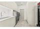 Modern laundry room with sleek white cabinetry, sink, and stainless steel washer and dryer units at 4934 Legacy Oaks Dr, Orlando, FL 32839
