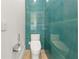 Modern powder room featuring a sleek toilet and stylish blue-green tile accent wall at 4934 Legacy Oaks Dr, Orlando, FL 32839