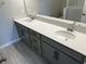 Elegant bathroom featuring a double sink vanity with quartz countertops and gray cabinets at 5101 Prairie Preserve Run, St Cloud, FL 34772