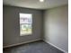Bedroom view featuring new gray carpeting and exterior scenery at 5101 Prairie Preserve Run, St Cloud, FL 34772