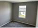 Bedroom view showcasing gray carpeting and exterior views at 5101 Prairie Preserve Run, St Cloud, FL 34772