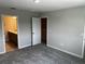 Bedroom featuring gray carpet, ensuite bath, and walk-in closet at 5101 Prairie Preserve Run, St Cloud, FL 34772